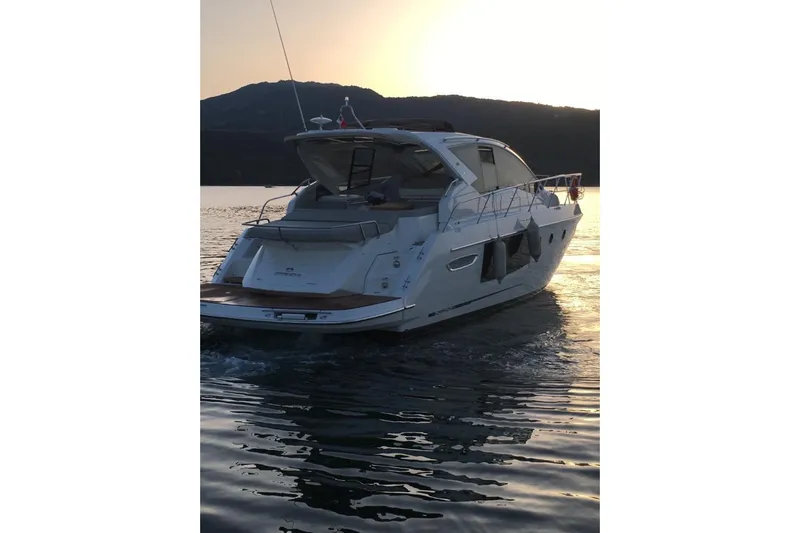  Yacht Photos Pics 2017 Cranchi M 44 HT yacht cruising at sunset on calm waters.