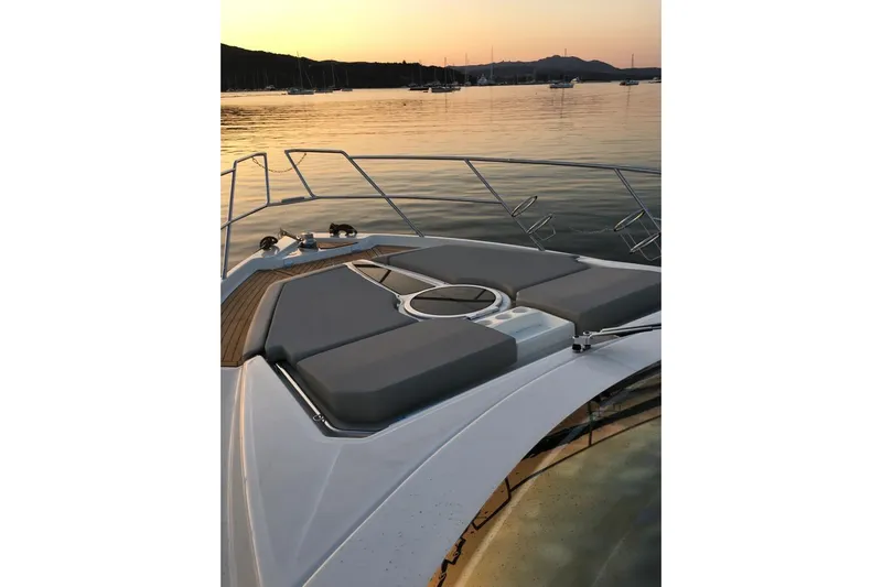  Yacht Photos Pics 2017 Cranchi M 44 HT yacht deck at sunset, calm waters, scenic view.