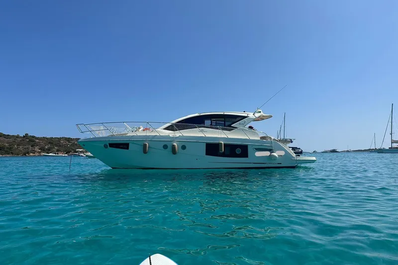  Yacht Photos Pics 2017 Cranchi M 44 HT yacht on clear blue water, sunny day.