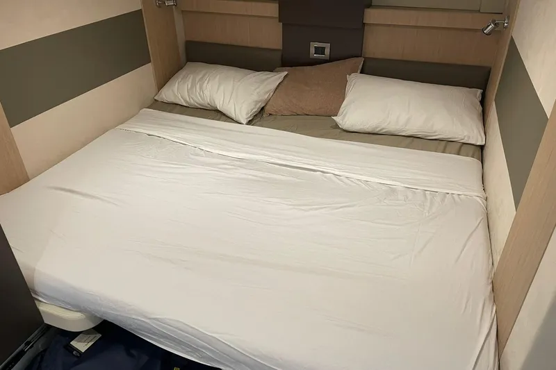  Yacht Photos Pics Cozy cabin bed in 2017 Cranchi M 44 HT yacht, featuring white linens and pillows.