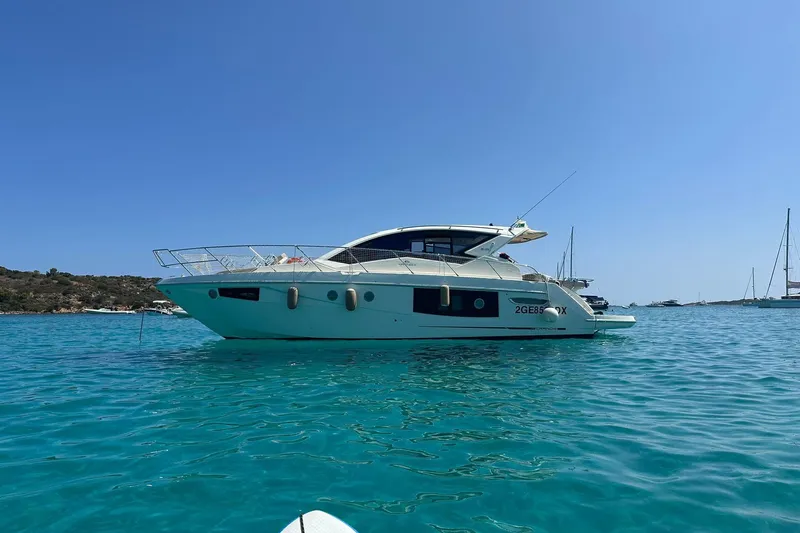  Yacht Photos Pics 2017 Cranchi M 44 HT yacht on clear blue water, sunny day, scenic background.