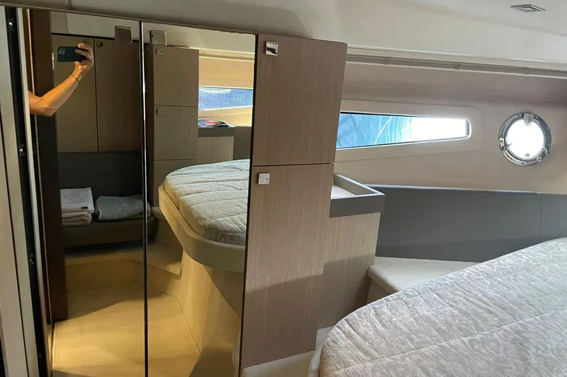  Yacht Photos Pics Interior of 2017 Cranchi M 44 HT yacht with modern bedroom design and porthole window.