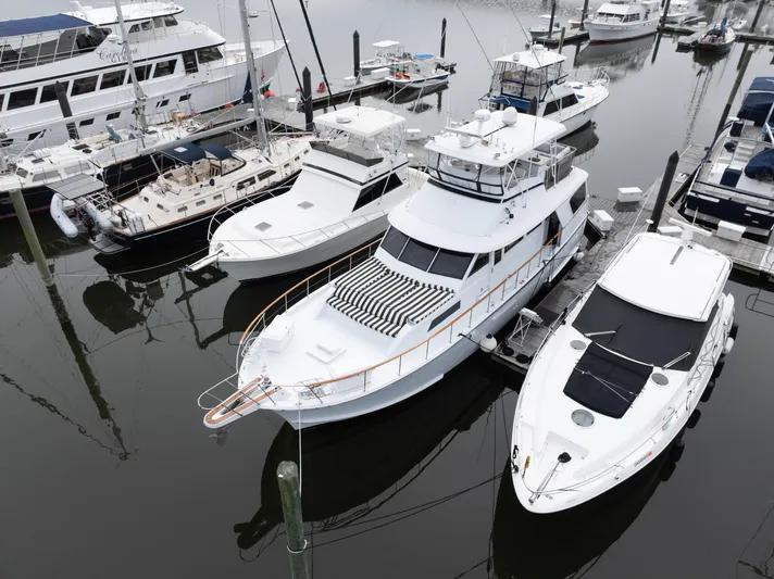  Yacht Photos Pics 1980 Hatteras 53 Motor Yacht docked among other boats in a marina.