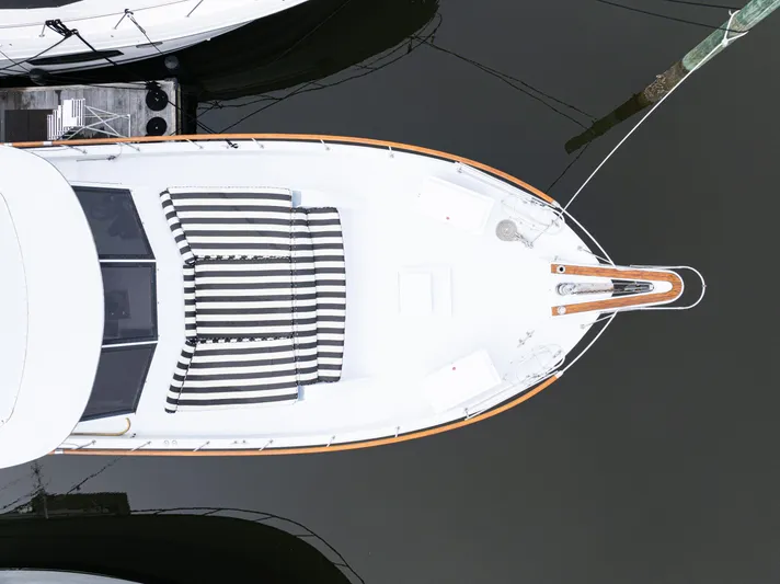  Yacht Photos Pics Overhead view of 1980 Hatteras 53 Motor Yacht docked, featuring striped deck cushions.
