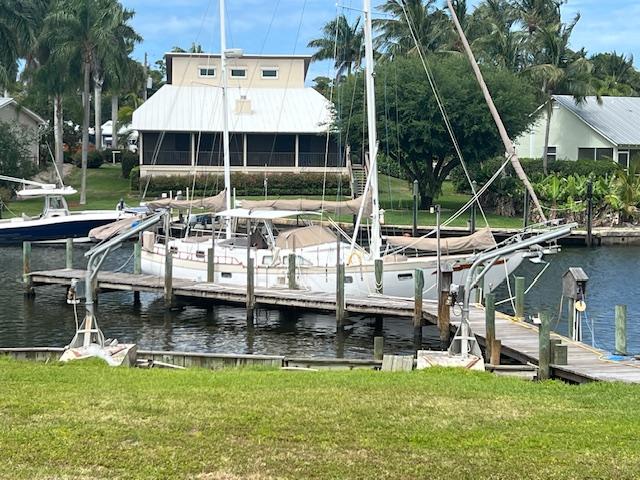 1981 Hardin Voyager 45 Ketch docked at a marina with lush surroundings.