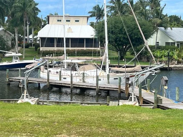 1981 Hardin Voyager 45 Ketch docked at a marina with lush surroundings.