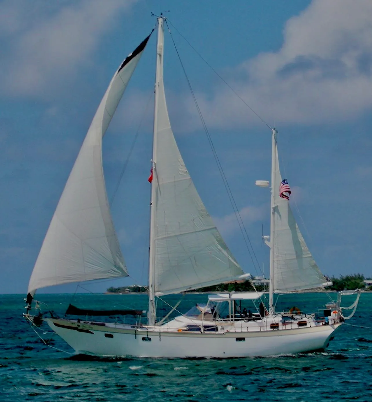 1981 Hardin Voyager 45 Ketch sailing on blue ocean under clear sky.