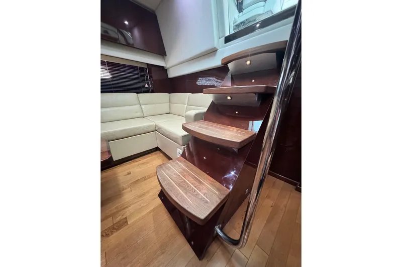 La Vie En Rose Yacht Photos Pics Interior of 2009 Sea Ray 470 Sundancer with wooden stairs and cream leather seating.