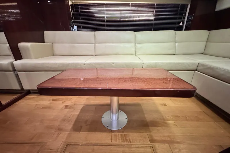 La Vie En Rose Yacht Photos Pics Luxurious interior of 2009 Sea Ray 470 Sundancer with beige seating and wooden table.