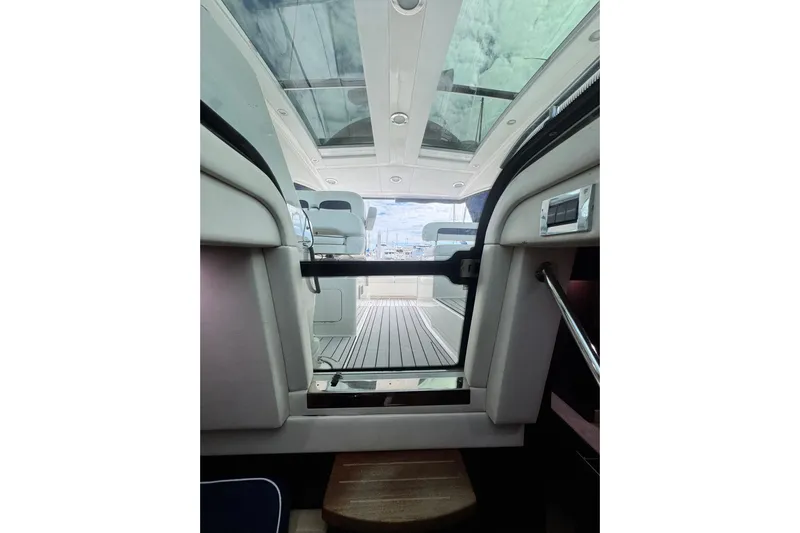 La Vie En Rose Yacht Photos Pics Interior view of 2009 Sea Ray 470 Sundancer yacht with open sunroof and seating area.