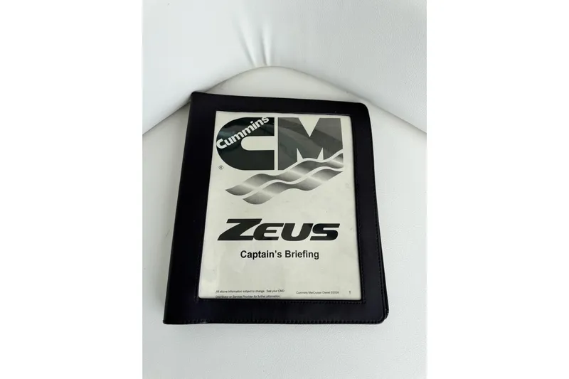 La Vie En Rose Yacht Photos Pics Cummins Zeus Captain's Briefing manual on white surface, related to 2009 Sea Ray 470 Sundancer.