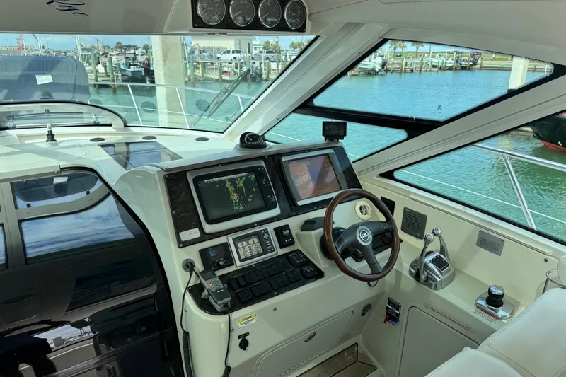 La Vie En Rose Yacht Photos Pics Interior helm of 2009 Sea Ray 470 Sundancer yacht with navigation equipment and steering wheel.