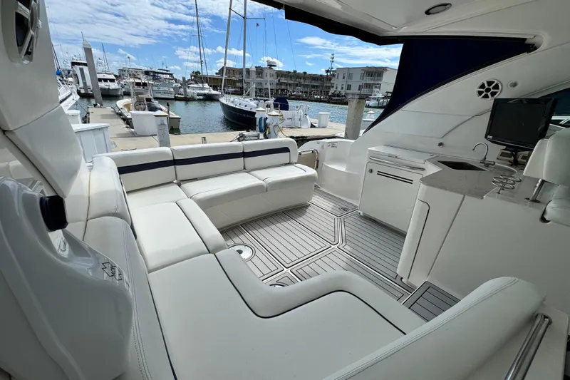 La Vie En Rose Yacht Photos Pics Luxurious 2009 Sea Ray 470 Sundancer yacht interior at marina, featuring elegant seating and amenities.