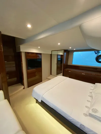  Yacht Photos Pics Luxurious bedroom interior of 2013 Princess 56 yacht with modern furnishings and ambient lighting.