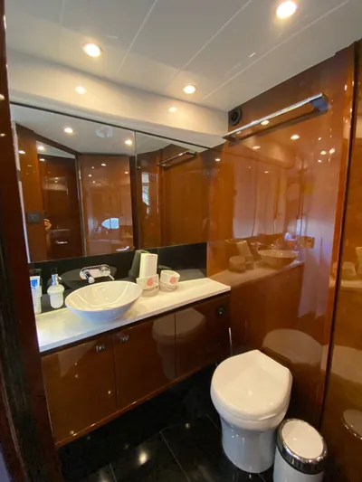  Yacht Photos Pics Luxurious bathroom in 2013 Princess 56 yacht with modern fixtures and wood paneling.