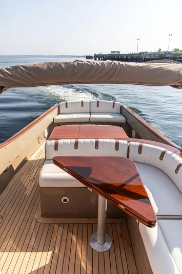 Fiveadrift Yacht Photos Pics Hinckley Talaria 29R 2003 boat interior with elegant wood and white seating.