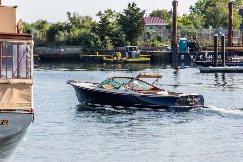 Fiveadrift Yacht Photos Pics 2003 Hinckley Talaria 29R cruising in a scenic harbor setting.