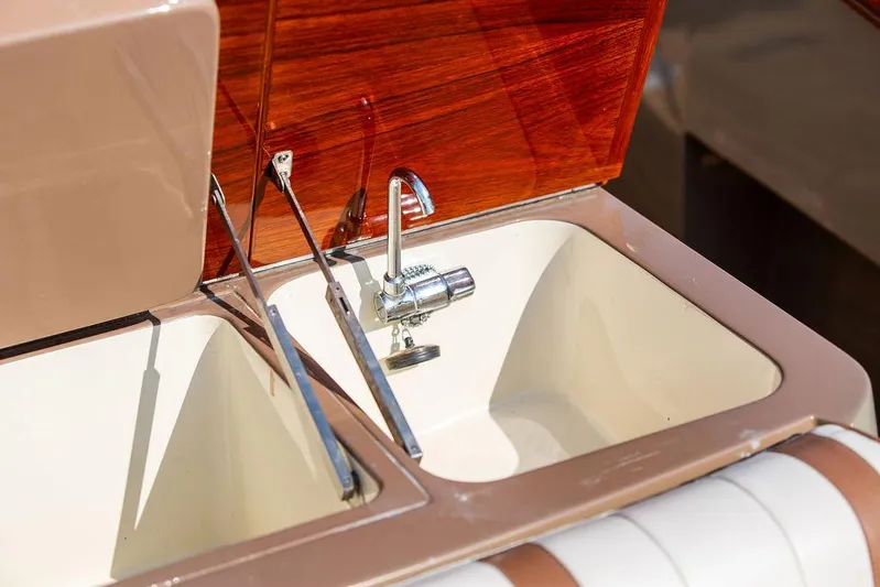 Fiveadrift Yacht Photos Pics 2003 Hinckley Talaria 29R boat sink with chrome faucet and wooden paneling.