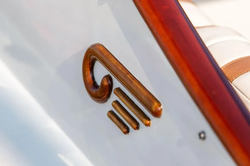 Fiveadrift Yacht Photos Pics Close-up of a wooden emblem on a 2003 Hinckley Talaria 29R boat.