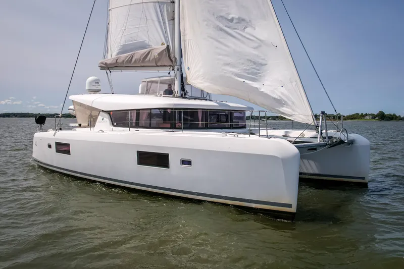 Reunited Yacht Photos Pics 2017 Lagoon 42 catamaran sailing on calm waters under clear skies.