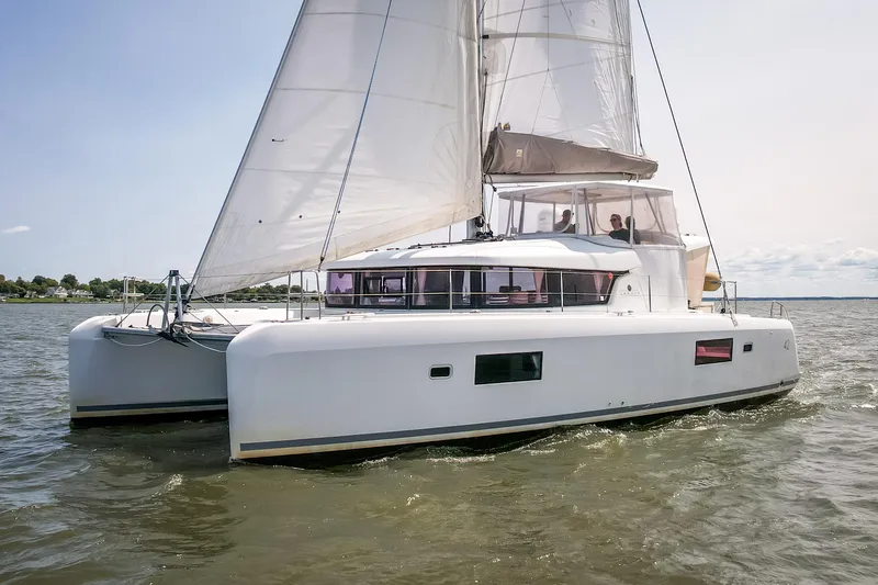 Reunited Yacht Photos Pics 2017 Lagoon 42 catamaran sailing on open water under clear skies.
