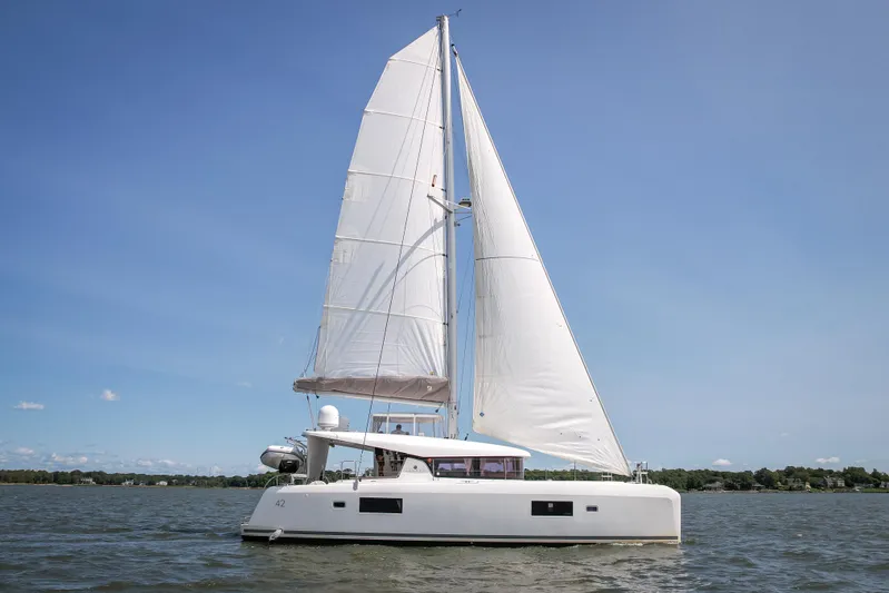 Reunited Yacht Photos Pics 2017 Lagoon 42 catamaran sailing on calm waters under clear blue skies.