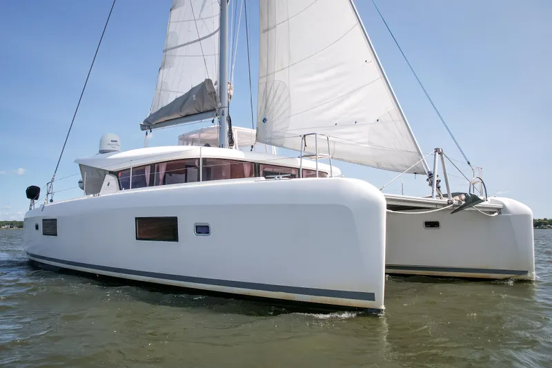Reunited Yacht Photos Pics 2017 Lagoon 42 catamaran sailing on calm waters under clear blue skies.