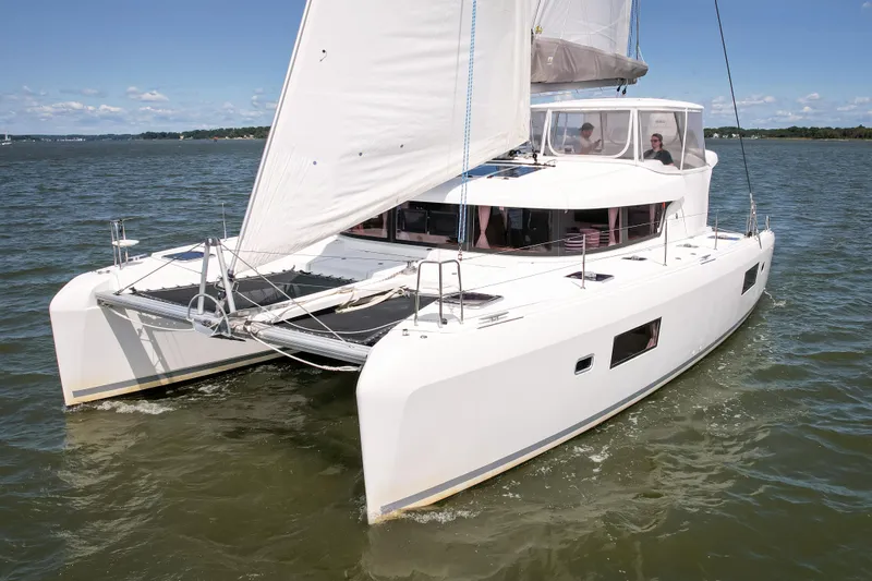 Reunited Yacht Photos Pics 2017 Lagoon 42 catamaran sailing on calm waters under clear skies.
