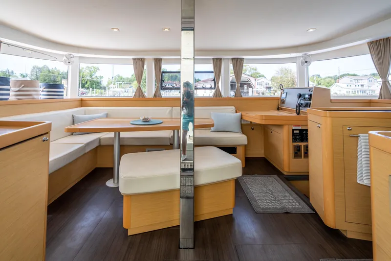 Reunited Yacht Photos Pics Interior of 2017 Lagoon 42 catamaran, featuring modern seating and panoramic windows.