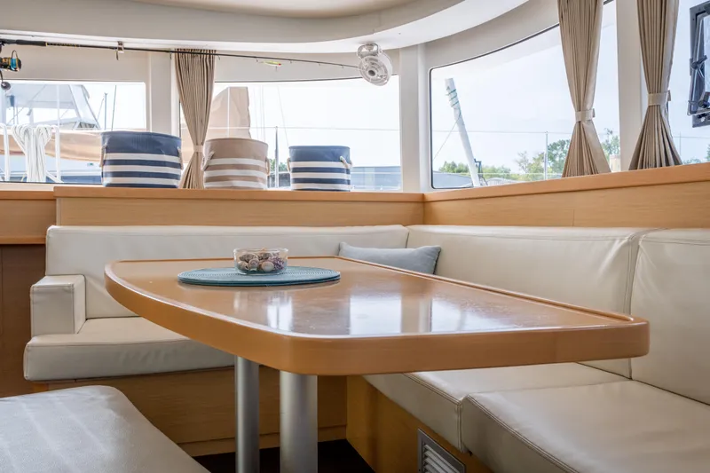 Reunited Yacht Photos Pics Interior of 2017 Lagoon 42 yacht with elegant dining area and comfortable seating.