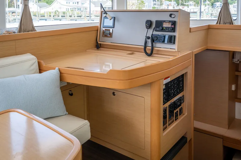 Reunited Yacht Photos Pics Interior of 2017 Lagoon 42 yacht with navigation station and seating area.