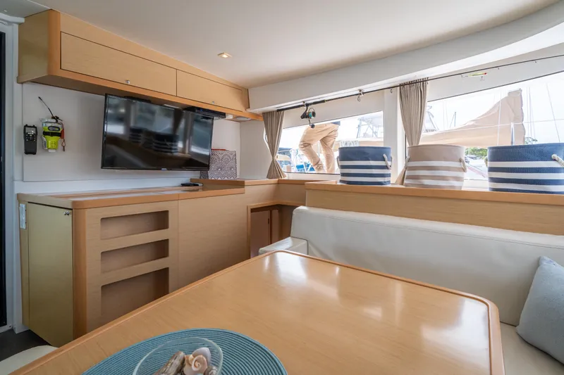 Reunited Yacht Photos Pics Interior of 2017 Lagoon 42 yacht with modern furnishings and large windows.