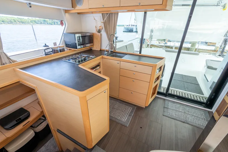 Reunited Yacht Photos Pics Modern kitchen interior of 2017 Lagoon 42 catamaran with sleek countertops and ample storage.