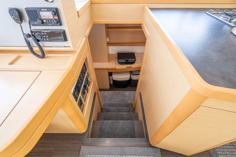 Reunited Yacht Photos Pics Interior of 2017 Lagoon 42 yacht showing stairs and navigation equipment.