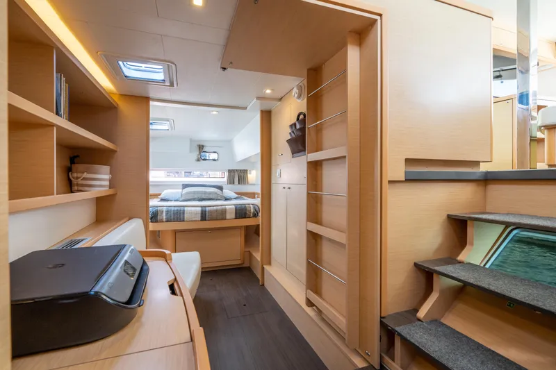 Reunited Yacht Photos Pics Interior of 2017 Lagoon 42 catamaran featuring cozy bedroom and modern workspace.