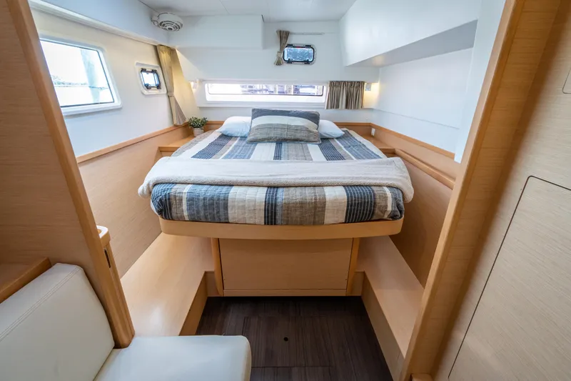 Reunited Yacht Photos Pics Luxurious cabin interior of 2017 Lagoon 42 catamaran with cozy bed and modern design.