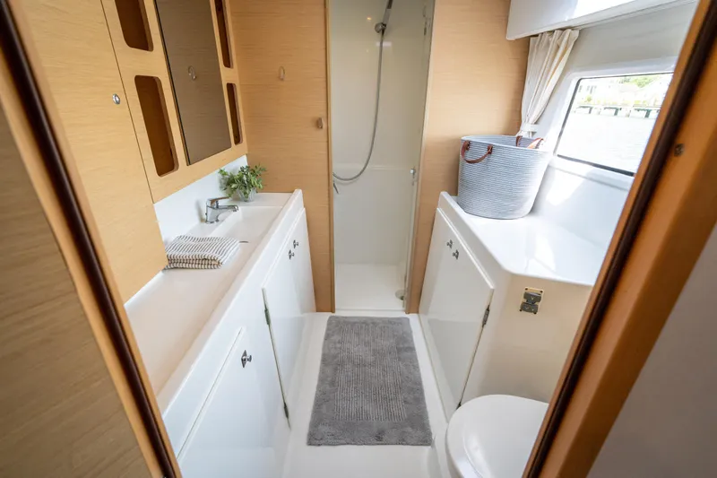 Reunited Yacht Photos Pics Modern bathroom interior of 2017 Lagoon 42 catamaran with shower and sink.