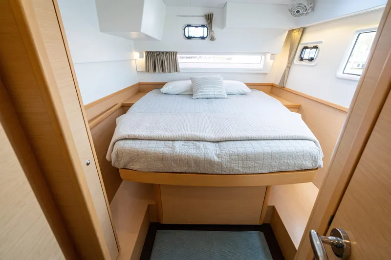 Reunited Yacht Photos Pics Luxurious cabin interior of 2017 Lagoon 42 catamaran with cozy bed and modern design.