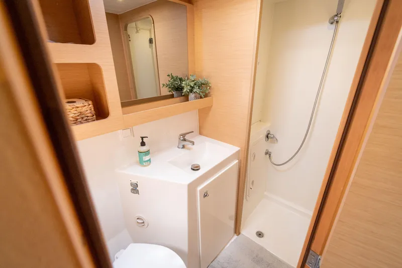 Reunited Yacht Photos Pics Bathroom interior of 2017 Lagoon 42 yacht with shower and sink.
