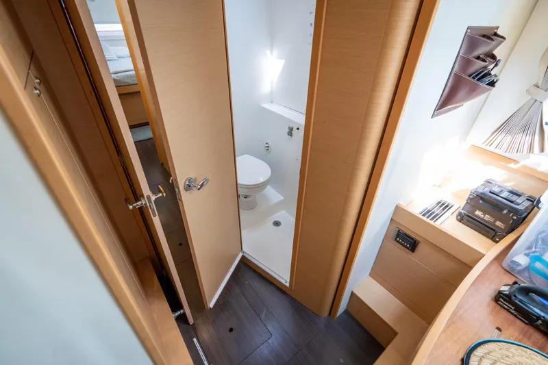 Reunited Yacht Photos Pics 2017 Lagoon 42 yacht interior bathroom with modern design and wooden accents.