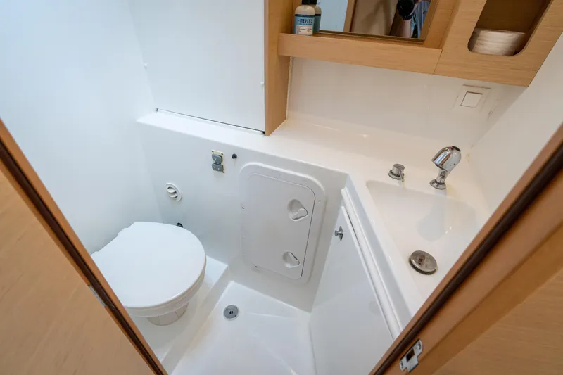 Reunited Yacht Photos Pics Compact bathroom in a 2017 Lagoon 42 yacht, featuring a toilet and sink.