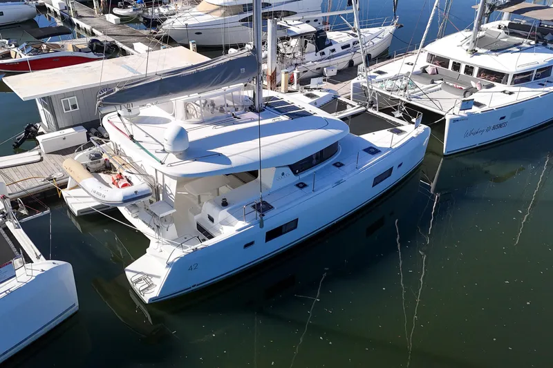 Reunited Yacht Photos Pics 2017 Lagoon 42 catamaran docked at marina, aerial view.