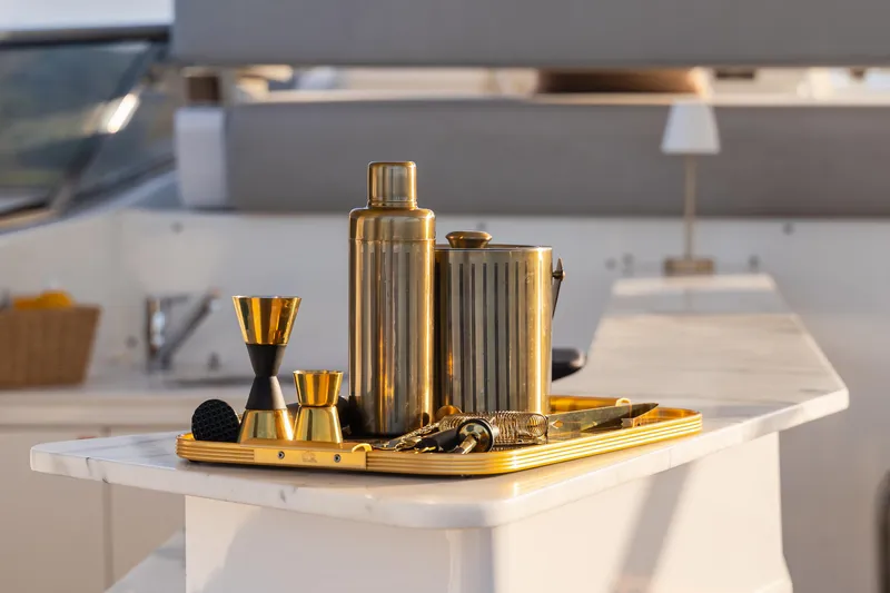  Yacht Photos Pics Luxurious bar set on Azimut Grande 32 Metri yacht, 2020 model, featuring gold cocktail accessories.