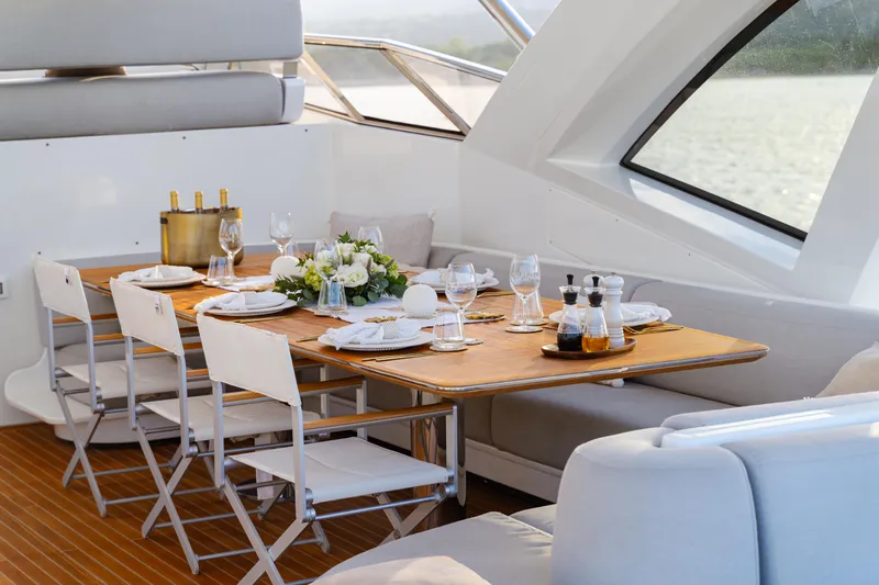  Yacht Photos Pics Luxurious dining setup on 2020 Azimut Grande 32 Metri yacht, featuring elegant tableware and decor.