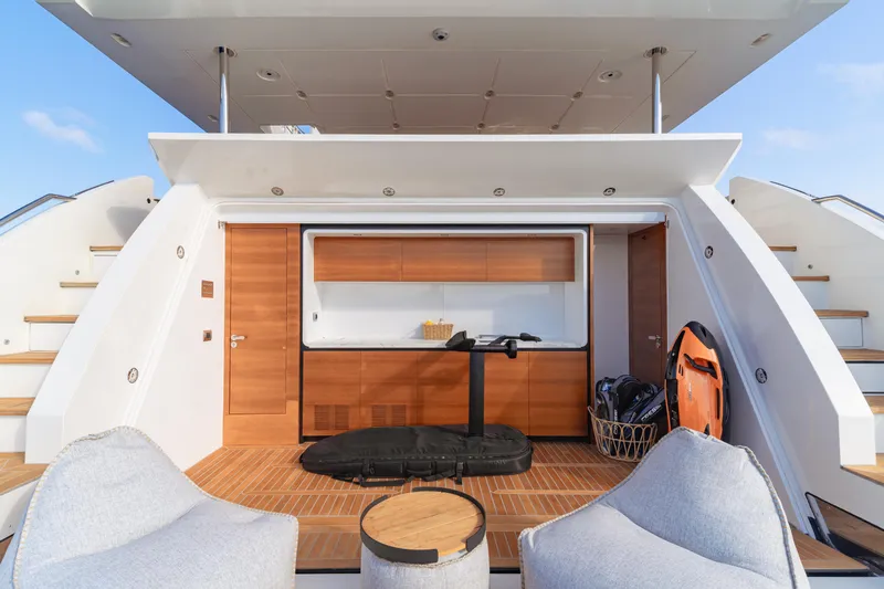  Yacht Photos Pics Luxury yacht deck with seating, storage, and water sports equipment, Azimut Grande 32 Metri 2020.