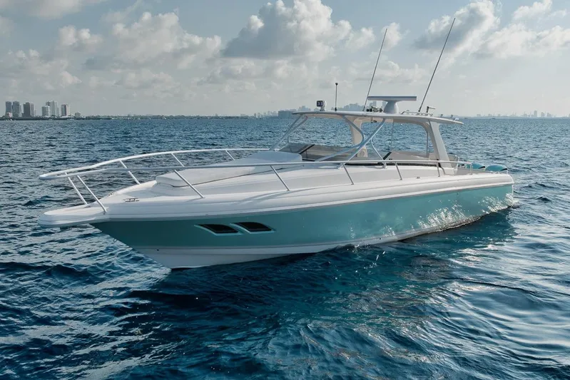  Yacht Photos Pics 2008 Intrepid 390 Sport Yacht cruising on open water under a partly cloudy sky.