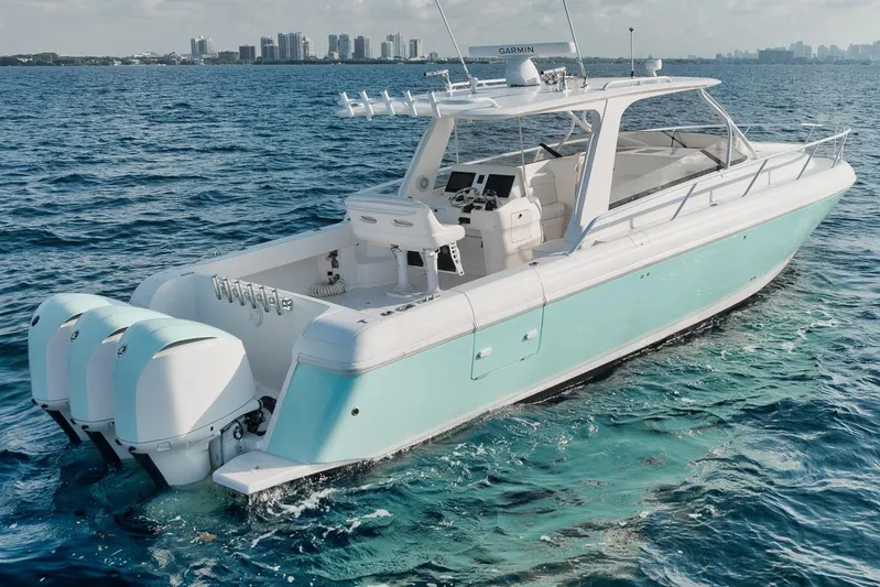  Yacht Photos Pics 2008 Intrepid 390 Sport Yacht cruising on blue ocean near city skyline.