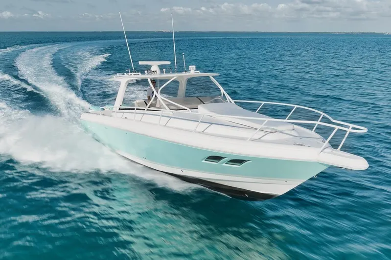  Yacht Photos Pics 2008 Intrepid 390 Sport Yacht cruising on clear blue ocean waters.