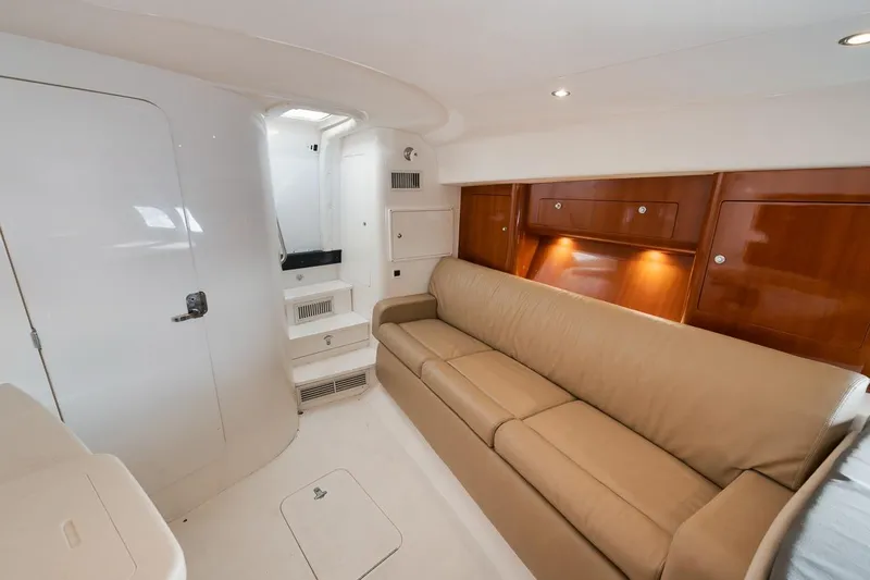  Yacht Photos Pics Luxurious interior of 2008 Intrepid 390 Sport Yacht with beige sofa and wooden cabinetry.