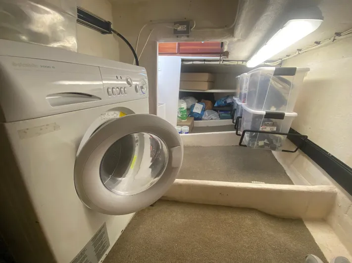 Korkzcrew Yacht Photos Pics Laundry area inside a 2008 Great Harbour N37 boat with washing machine and storage bins.